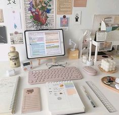 a desktop computer sitting on top of a white desk next to a keyboard and mouse