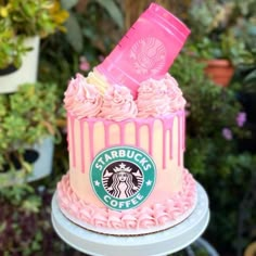 a starbucks cake with pink frosting on top