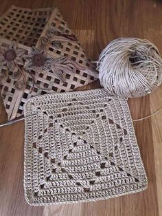 two pieces of crochet sitting on top of a wooden floor