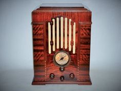 an old fashioned wooden radio with two dials