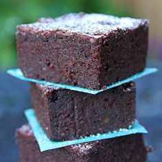 three pieces of chocolate cake sitting on top of each other