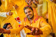 a group of people standing around each other with hendis on their heads and hands