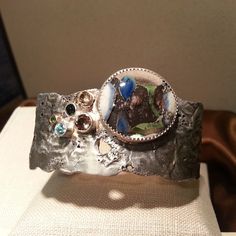 "EARTH" - one of the pieces in my  ArtPrize collection. A sterling silver reticulated cuff bracelet showcasing one of my lampwork glass cabochons and 5 brilliant gemstones!!!! Head down to the Amway Grand Plaza Hotel to take a look at my entire collection! "eleMENTALity"  www.etsy.com/shop/entertheflame.com Wearable Art