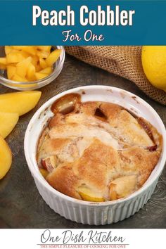 A mini peach cobbler in a small white ramekin on a silver tray next to fresh peaches and lemons Peach Cobbler For One Person, Peach Cobbler Ramekin, Peach Desserts For One, Single Peach Cobbler, Mug Peach Cobbler, Small Batch Peach Desserts, Personal Peach Cobbler, Small Batch Peach Cobbler