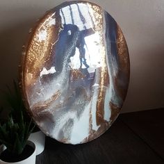 a plate sitting on top of a wooden table next to a potted succulent