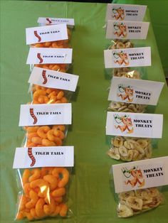 there are many snacks on the table with name tags attached to them that say tiger tails