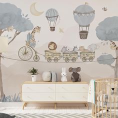 a baby's nursery room decorated in neutral tones with animals, giraffes and hot air balloons