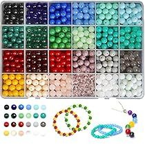 beads and bracelets are arranged in an organized box with beading supplies for making necklaces