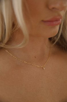 Achieve an elegant look with this dainty gold necklace. Featuring a delicate yet durable gold chain and subtle charm, this necklace stands out without being overbearing. Perfect for adding a finishing touch to your look. 18k gold dipped waterproof hypoallergenic rhinestone charm dainty chain Everyday Delicate Cubic Zirconia Charm Necklaces, Delicate Gold Plated Charm Necklace With Delicate Chain, Dainty Cubic Zirconia Delicate Chain Necklace, Dainty Cubic Zirconia Chain Necklace With Delicate Chain, Dainty Gold-plated Charm Necklaces With Gold Chain, Dainty Gold-plated Charm Necklace With Gold Chain, Delicate Gold Charm Necklace With Cubic Zirconia, Dainty Gold Chain Charm Necklace, Dainty Chain Necklace