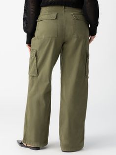 DETAILS Standard Rise Relaxed Fit Cargo Pant Micro-Sanded Super Soft Baby Twill Fabric Button/ Zipper Closure Fastener Detail at Hips Functional Cargo Pockets Also Available in XXS-XXL. SIZE + FIT Model is 5'10 wearing a size 1X. Waist: 39 1/2" Front Rise: 12 1/2" Inseam: 32 1/2" Leg Opening: 23" FABRIC + CARE 97% Cotton 3% Spandex Twill Style is Pre-Washed and Garment-Dyed. Machine Wash Cold, Tumble Dry Low. Imported BETTER COTTON'S MISSION By choosing our cotton products, you're supporting our Wide Leg Cargo Pants, Cotton Cargo Pants, Mossy Green, Baskets Adidas, Karl Kani, Baggy Pant, Pantalon Cargo, Military Inspired, Cargo Pant