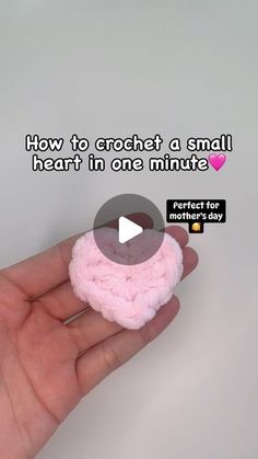 a person holding a small pink object in their hand with the caption how to crochet a small heart in one minute