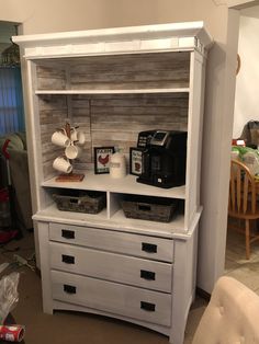 a white hutch with drawers and baskets on top