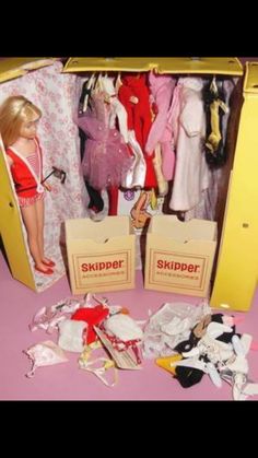 a barbie doll is standing in a closet full of clothes and other items on the floor