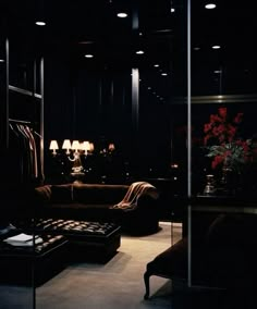 a dimly lit room with couches, lamps and other items in the dark area