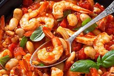 a bowl filled with shrimp and tomato sauce