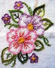 a close up of a piece of cloth with flowers embroidered on the front and back