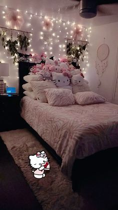 a hello kitty themed bedroom with pink and white decorations on the wall above the bed