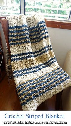 a crochet striped blanket sitting on top of a chair