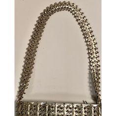 French designer Paco Rabanne is best known for his revolutionary 1968 dresses made from metal discs and rings. This rare handbag soon followed, made from the same materials. The bag has a shoulder strap, an interior silver leather pouch which has a metal zipper, a fabric lining, and the Paco Rabanne label.  It is in excellent condition, with very minor loss to the finish on three of the discs making up the shoulder strap. Measurements; Length 9"  Height 6"  Depth 1.5" Metal Evening Bag, Evening Metal Chain Shoulder Bag, Silver Metal Rectangular Bag, Silver Evening Shoulder Bag With Chain Strap, Vintage Shoulder Bag With Silver-tone Hardware, Metal Shoulder Bag For Evening, Evening Shoulder Bag With Metal Chain Strap, Silver Rectangular Shoulder Bag With Chain, Elegant Metal Rectangular Shoulder Bag