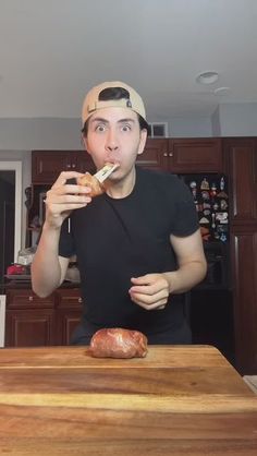 a man is brushing his teeth while standing in front of a cutting board with food on it