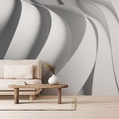 a living room with a couch, table and large wall paper in the background that looks like wavy lines