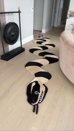 a long line of black and white rugs on the floor in a living room