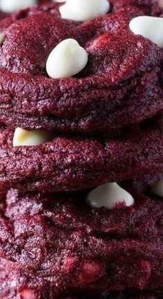 a stack of red velvet cookies with white chocolate chips and marshmallows on top