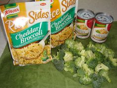 broccoli and other foods are sitting on the table next to cans of soda