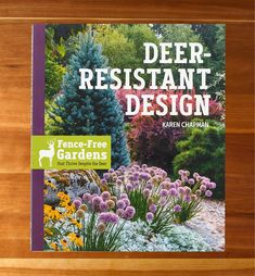 the book cover for deer - resistant design is shown on a wooden surface with flowers and plants