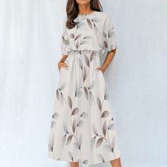 Introducing our "Boho Breeze" short sleeve midi dress - a perfect fusion of style and comfort. This dress boasts a crewneck design, short sleeves, and a flattering fit-and-flare silhouette that exudes bohemian charm. The 4-way stretch fabric, crafted from a blend of 95% polyester and 5% spandex, ensures optimal comfort and flexibility for all-day wear.  The regular fit and elastic waistband provide a tailored look while allowing for easy movement. With convenient pockets, this dress seamlessly c Casual Half Sleeve Maxi Dress For Vacation, Casual Midi-length Short Sleeve Beach Dress, Casual Midi Length Short Sleeve Beach Dress, Casual Printed Short Sleeve Midi Dress, Modest Short Sleeve Midi Dress For Beach, Casual Flowy Half Sleeve Maxi Dress, Casual Printed Midi Dress With Half Sleeves, Casual Beach Midi Dress With Half Sleeves, Casual Half Sleeve Midi Dress For Vacation