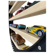 toy cars are lined up on wooden shelves