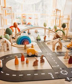 a child's play area with wooden toys on the floor