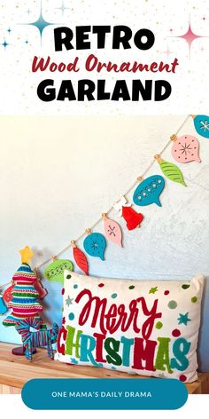 a christmas pillow with the words retro wood ornament garland on it and a small tree next to it