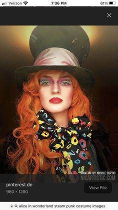 a close up of a doll wearing a hat and dress with red hair in front of a light