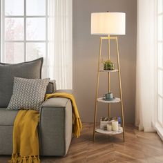 a living room scene with focus on the floor lamp and sofa in the foreground