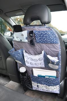 the back seat of a car with various items in it and an organizer hanging from the side