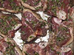 raw meat with herbs and seasoning in a pan