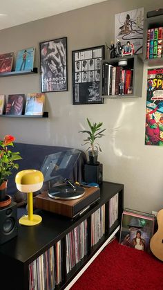 a living room filled with furniture and lots of movies on the wall above it's bookshelf