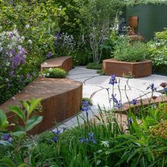 an outdoor garden with various plants and flowers