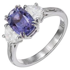 Sapphire and diamond engagement ring. GIA certified purple cushion cut center sapphire, changes color from violet blue to purple in different lights. Set in a platinum three-stone setting with 2 Art Deco step cut shield side diamonds. The sapphire is Natural certified no heat no enhancements. Created in the Peter Suchy Workshop like the original. 1 antique cushion old cut color change violet blue to purple Sapphire, approx. total weight 3.07ct, VS, 9.33 x 6.52 x 5.60mm, natural color, no heat an Purple Cushion, Platinum Engagement Rings Vintage, Sapphire And Diamond Engagement Ring, Antique Cushion, Emerald Cut Diamond Engagement, Contemporary Engagement Rings, Modern Engagement Rings, Bleu Violet, Engagement Ring Diamond Cut