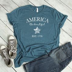 Our shirts are handmade in Ohio by hand with love and care one at a time. We hope you will find a shirt that will inspire you or someone else. This America the beautiful shirt is a must. We use a high-quality unisex t-shirt that is insanely soft. In fact, it will be one of the softest, best fitting, most comfortable shirts you've ever owned. CLICK BELOW https://www.etsy.com/shop/WalnutRidgeCo DETAILS: - This is for 1 graphic shirt. - Available in sizes S-2XL - These are UNISEX fit. - Please refe Pre-shrunk Tri-blend Summer Shirt, Summer Tri-blend Crew Neck Shirt, Summer Shirt With Text Print For Everyday, Summer Tri-blend Shirt With Graphic Print, Casual Soft-washed T-shirt For 4th Of July, Relaxed Fit Cotton Shirt For Independence Day, Casual Independence Day Shirt With Text Print, Lake Life Shirt, Braves Shirts