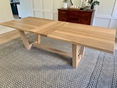 a wooden table sitting on top of a rug