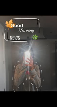 a man taking a selfie in front of a mirror with the words good morning on it