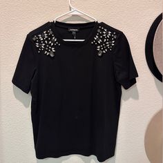 Beautiful Black Embellished T-Shirt Brand New With Tags. You Can Wear It With A Skirt For A Night Out Or With A Pair Of Jeans For A Casual Day Out. Embellished Graphic Tee With Short Sleeves, Embellished Graphic Tee With Crew Neck, Embellished Crew Neck T-shirt For Spring, Spring Embellished Crew Neck T-shirt, Casual Embellished T-shirt For Party, Black Embellished T-shirt For Party, Summer Black Embellished T-shirt, Trendy Embellished Black Tops, Trendy Black Embellished Tops