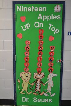 a classroom door decorated with pictures of people and animals on top of the words nineteen apples up on top