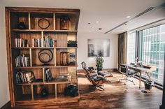 a living room filled with furniture and a book shelf next to a sliding glass door