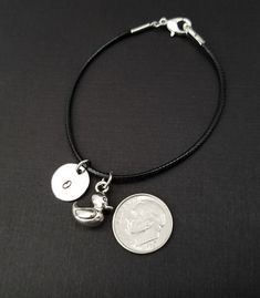 "Personalized Waxed Cord Bracelet! A three dimensional rubber duck charm on a black waxed cord makes the perfect gift for your best friend. The duck charm is made from zinc alloy and measures 12 mm by 5 mm. The charm is reversible. The bracelet is a waxed braided rope and measures 7.25\" with a 1-2\" extender (see last picture). The lobster clasp is zinc alloy. The black cord bracelet can be personalized with a .5\" silver plated disc stamped with the initial of your choice. Each personalized br Adjustable Black Bracelets With Charms, Duck Bracelet, Adjustable Black Charm Bracelet With Lobster Clasp, Black Charm Bracelet With Lobster Clasp, Duck Call Lanyard, Bracelet Best Friends, Duck Jewelry, Duck Key Chain, Rubber Duck Earrings