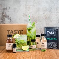 an assortment of drinks and condiments sitting on a table next to a box