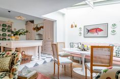 a living room filled with furniture next to a kitchen and dining room table in front of a white piano