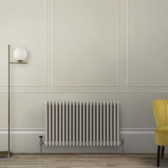 a white radiator sitting next to a yellow chair